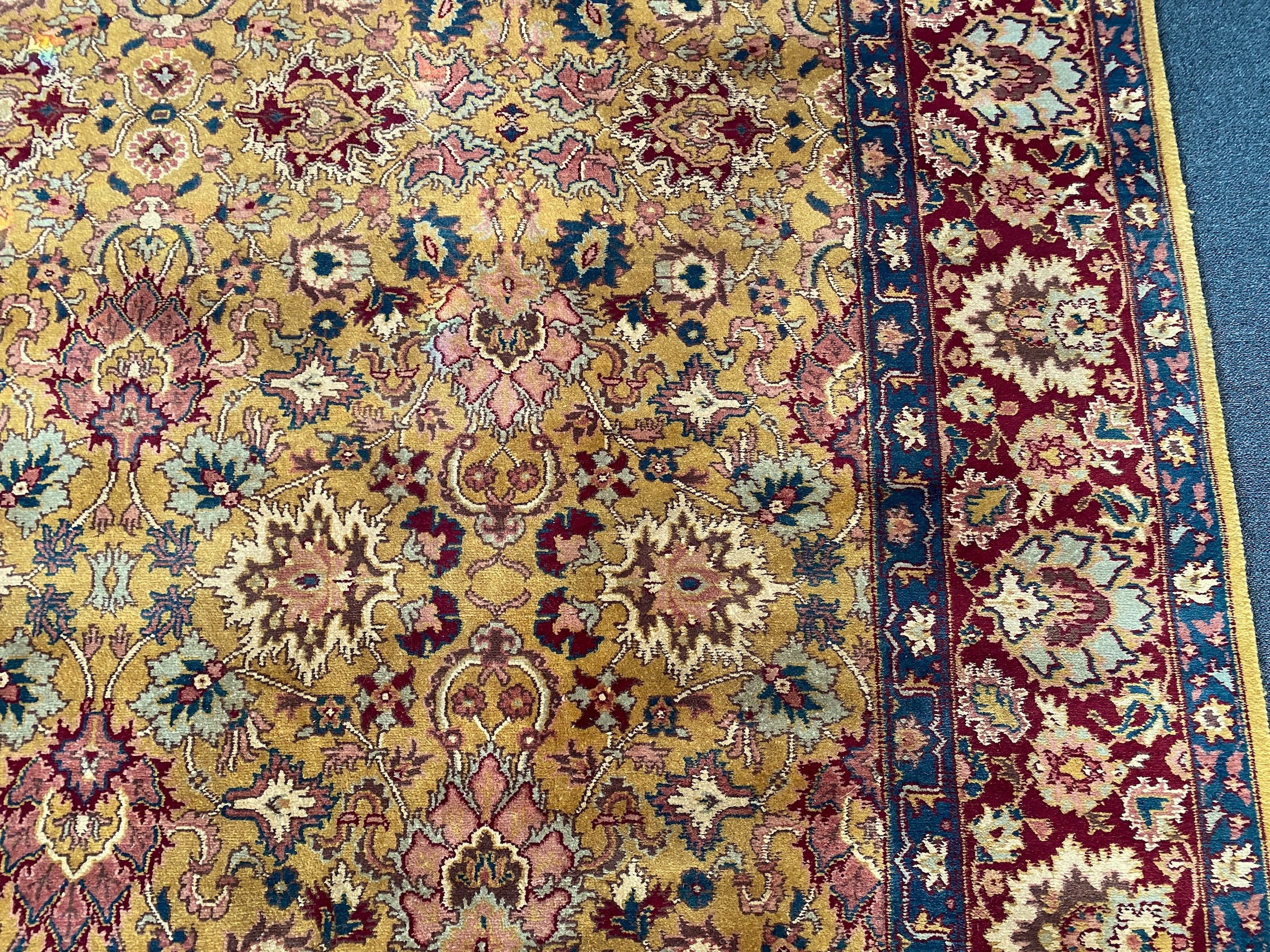 An Agra gold ground carpet with dense palmette field and wide conforming border 360 x 280 cms